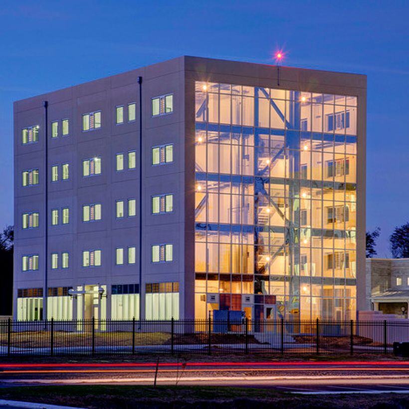 building with windows in front of a fence