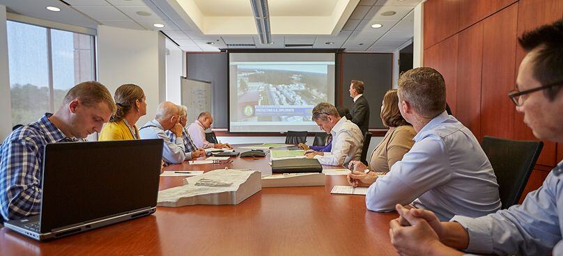 people surrounding conference table