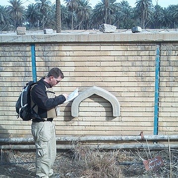 man reading map with backpack on
